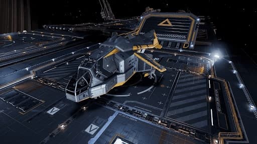 A silver and mustard coloured Diamondback Explorer landed on a similarly coloured fleet carrier